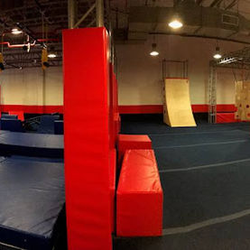 Spacious obstacle training area with trampolines and foam features at Ninja Republic in San Mateo, C
